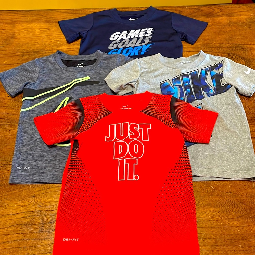 Set of 4 Nike 4T athletic tops.